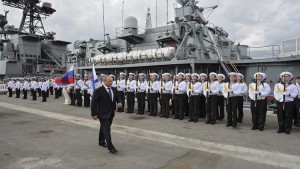 Russian President Vladimir Putin attends a welcoming ceremony as he inspects the Vice-Admiral Kulakov anti-submarine warfare ship in Novorossiysk